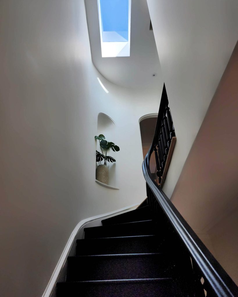 A curving staircase is the focal point of this home.